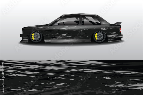 Sleek black sports car with racing stripes on track