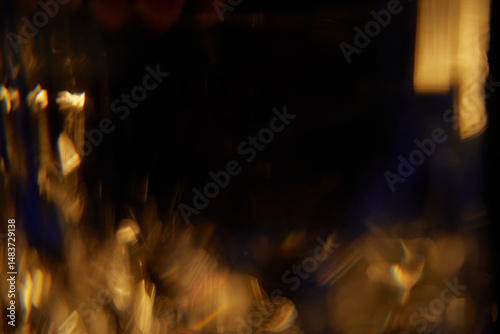 Abstract light leaks on black background with copy space. Studio lens flare bokeh effect.