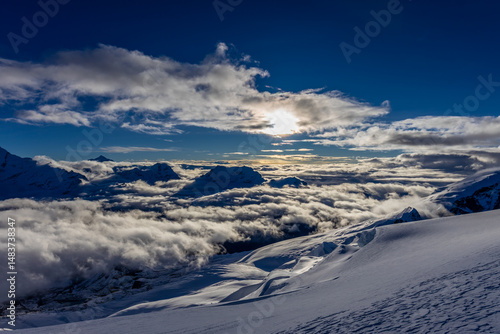 Mera Peak high altitude mountain summit ascent in Himalayas. Stunning views above the clouds at sunrise from the top of the mountain. Alpine route climbing on the snow path in Himalayas