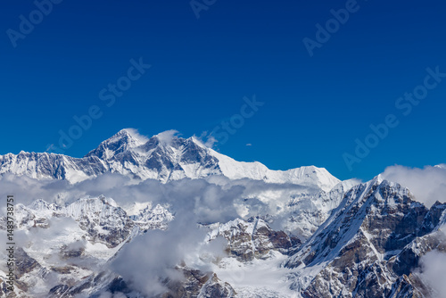 Mera Peak high altitude mountain summit ascent in Himalayas. Stunning views above the clouds at sunrise from the top of the mountain. Alpine route climbing on the snow path in Himalayas