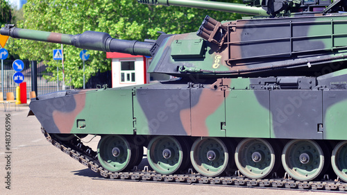 Heavy military tank vehicle turret gun aiming on a target and ready to fire. The rotating turret barrel tip of a tank. Detail shot with the  turret barrel tip of a modern tank.