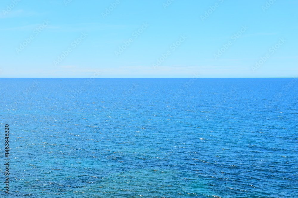 Fototapeta premium Budva, Montenegro - May 04, 2024 : The Old Town Fortress in Budva. A stone wall on the shore of the Adriatic Sea in Montenegro. Horizontal. On a hot, sunny, spring afternoon. 