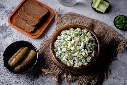 Cucumber egg mayonnaise salad in a bowl on a grey background