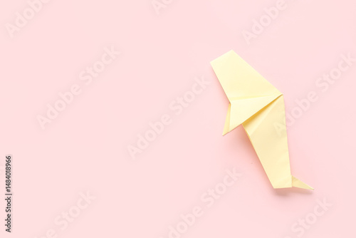 Yellow origami whale on pin...