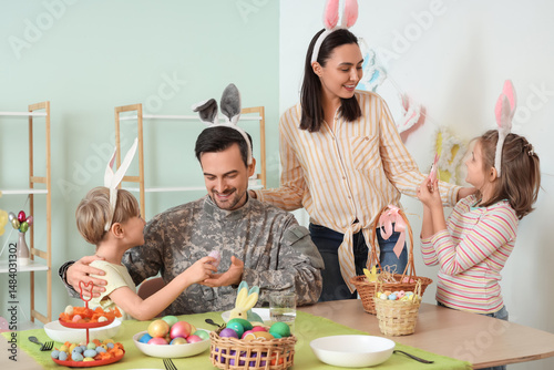 Male soldier with his famil...
