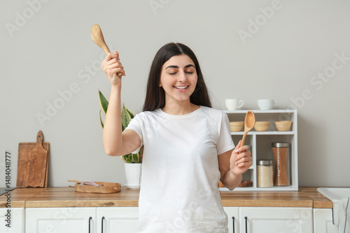 Happy young woman cooking w...