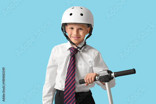 Cute schoolboy in helmet wi...