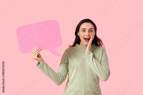 Surprised young woman holdi...