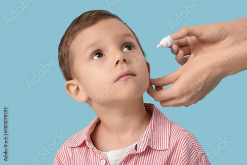 Female doctor putting drops...