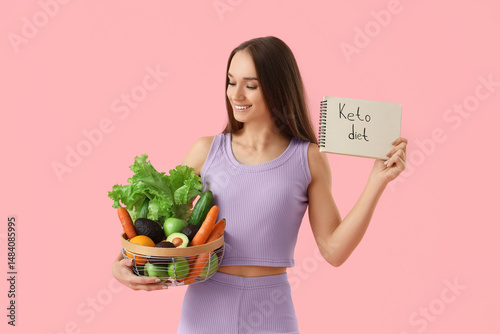 Sporty young woman holding ...