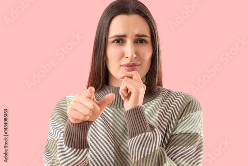 Wondering young woman point...