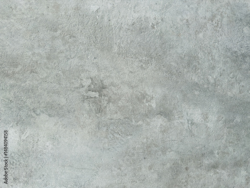 Detailed close-up of a textured light grey surface resembling aged concrete or plaster with subtle variations and marks, perfect for backgrounds