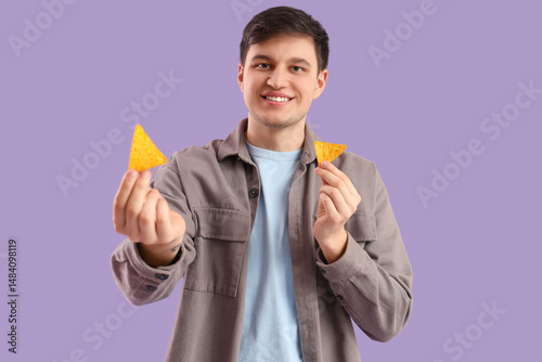 Young man with tasty nachos...
