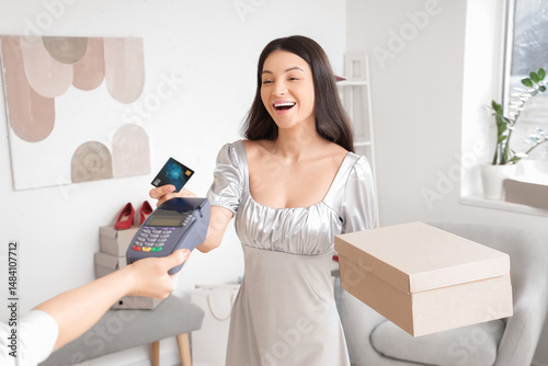 Young woman paying via term...