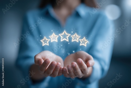 Person holding five glowing stars in cupped hands against a blurred blue background shot