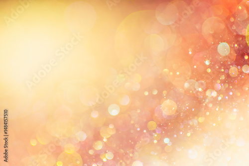 Glittering abstract background in blurry warm fall colors. Defocused background with a sparkling bokeh in vibrant yellow, orange, and red.