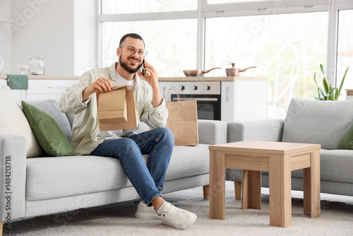 Young man with paper bags t...