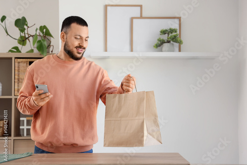 Young man with paper bag an...
