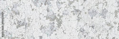 Peeling paint on the wall. Old concrete wall with cracked flaking paint. Weathered rough painted surface with patterns of cracks and peeling. Grunge texture for background and design. High resolution.