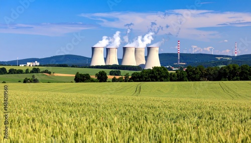 Panoramic view of a power station with cooling towers amidst rural landscape