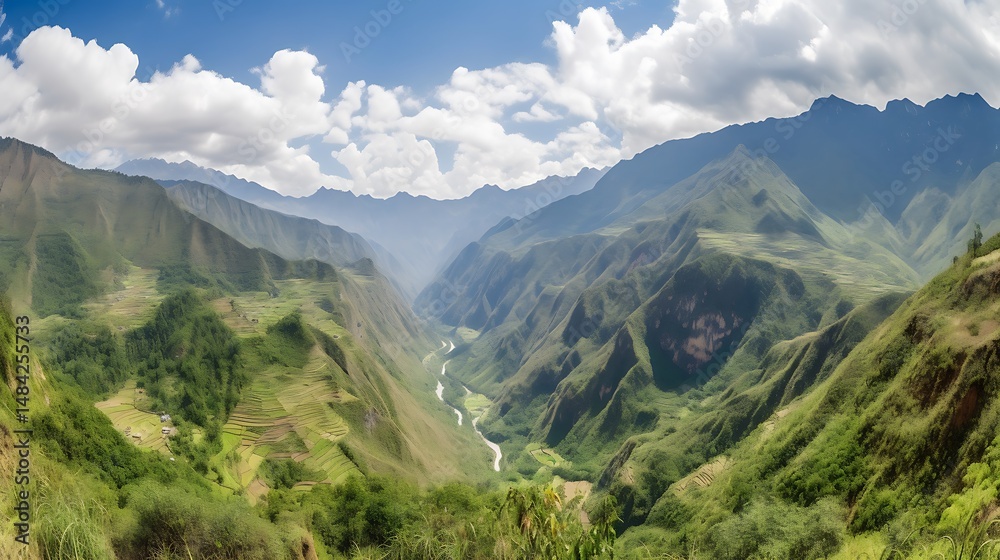 Fototapeta premium Lush green valley with mountains and clouds.