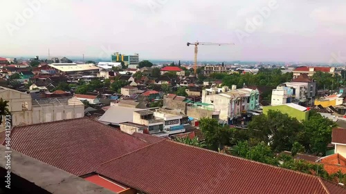 A vibrant atmosphere of Surakarta city, where tradition and modernity blend seamlessly. The city is filled with cultural landmarks, bustling markets, historical architecture, and the warmth of Javanes