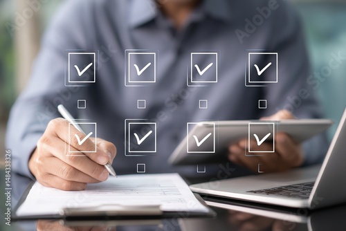Business performance monitoring and evaluation concept, Take an assessment, Business man using laptop and tablet online checklist survey, Filling out digital checklist, Questionnaire with checkboxes.