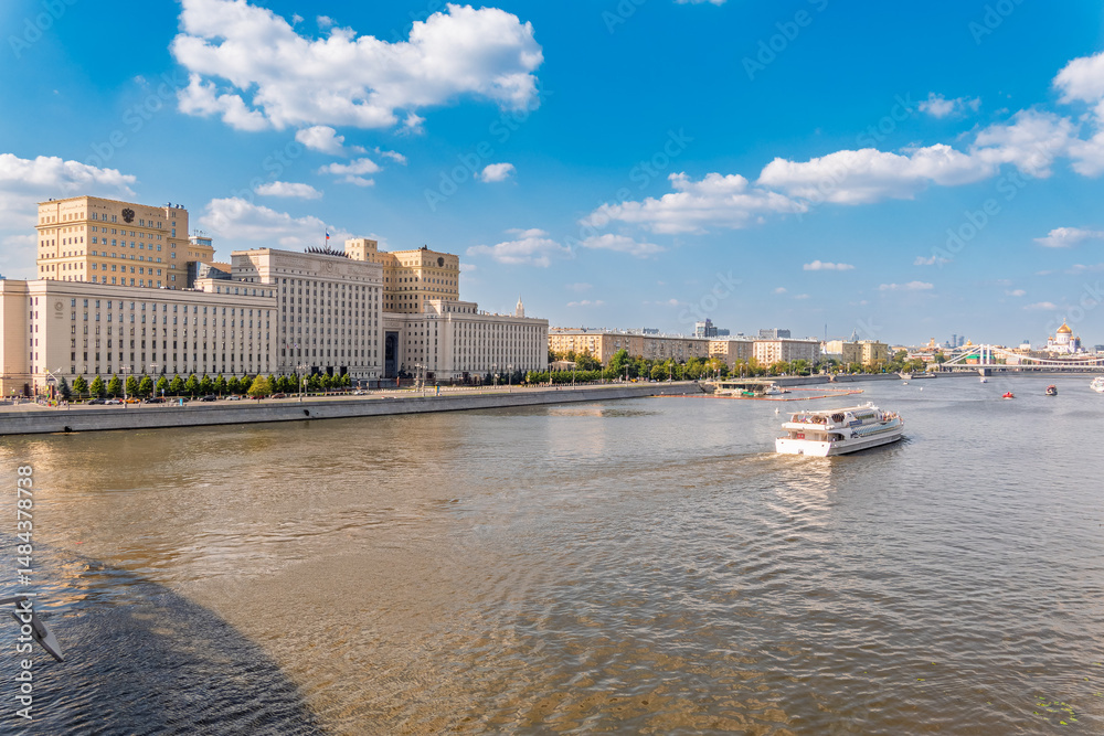 Naklejka premium View of the Ministry of Defence of Russian Federation, and Moscow river embankment with cruise ships at sunset.