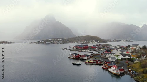 Breathtaking aerial view of majestic mountains enveloped in morning mist at Lofoten Islands, Norway, capturing serene natural beauty and dramatic Nordic landscapes.