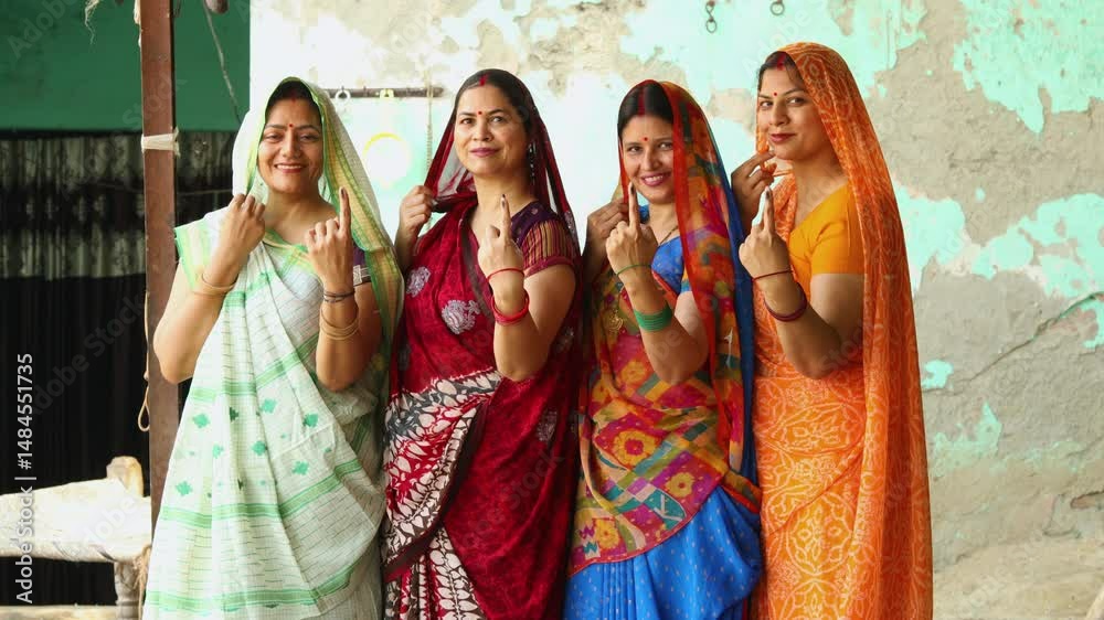 Election in india. Group of rural indian women standing in queue showing finger after casting vote. Voters.