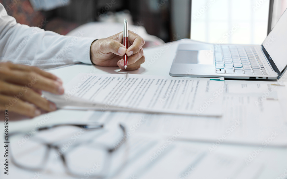 Fototapeta premium asian businessman working on desk reading and checking financial documents and business contract to make new business plan