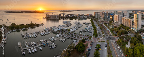 Photos Aerial view of Sarasota city downtown at sunset with bay marina yachts and high-rise office buildings