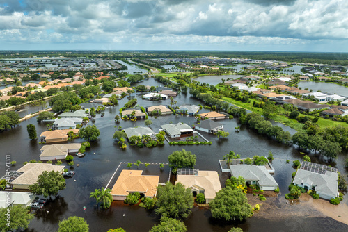 Flooded houses from hurricane rainfall water in Florida residential community. Aftermath of natural disaster in USA south