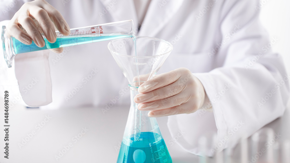 Fototapeta premium Hands Performing Scientific Experiments in a Modern Laboratory Setting.