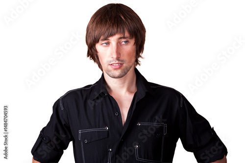 Casual portrait of a young man with a stylish haircut indoors