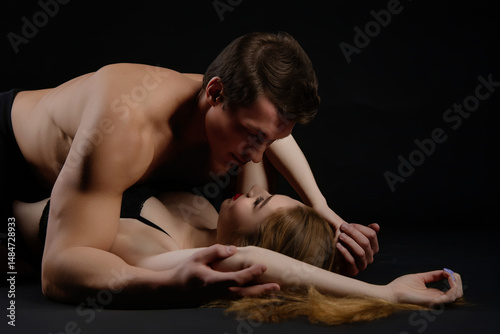 Couple embraces intimately in a sensual moment capturing beauty and desire