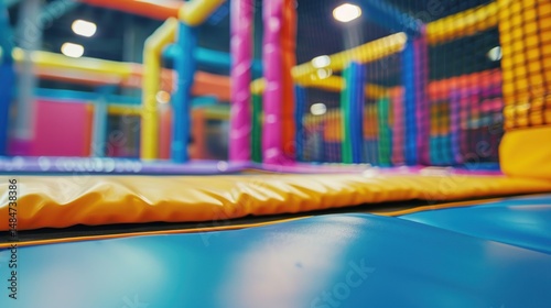 Wallpaper Mural Indoor blurred view of trampoline in kids play area with colorful tones Torontodigital.ca