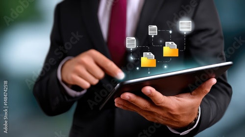 Professional managing digital files on a tablet with modern technology visuals.