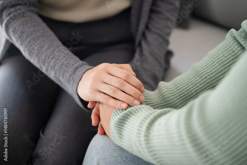 Psychologist, friend or family holding hands to encourage patient with depression, anxiety