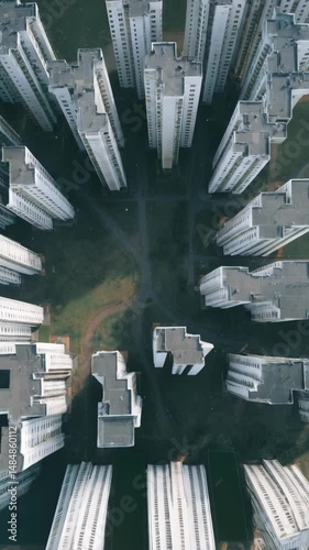 Aerial view of generic high-rise apartment buildings forming a symmetrical pattern, with lawns and walkways in the common areas.