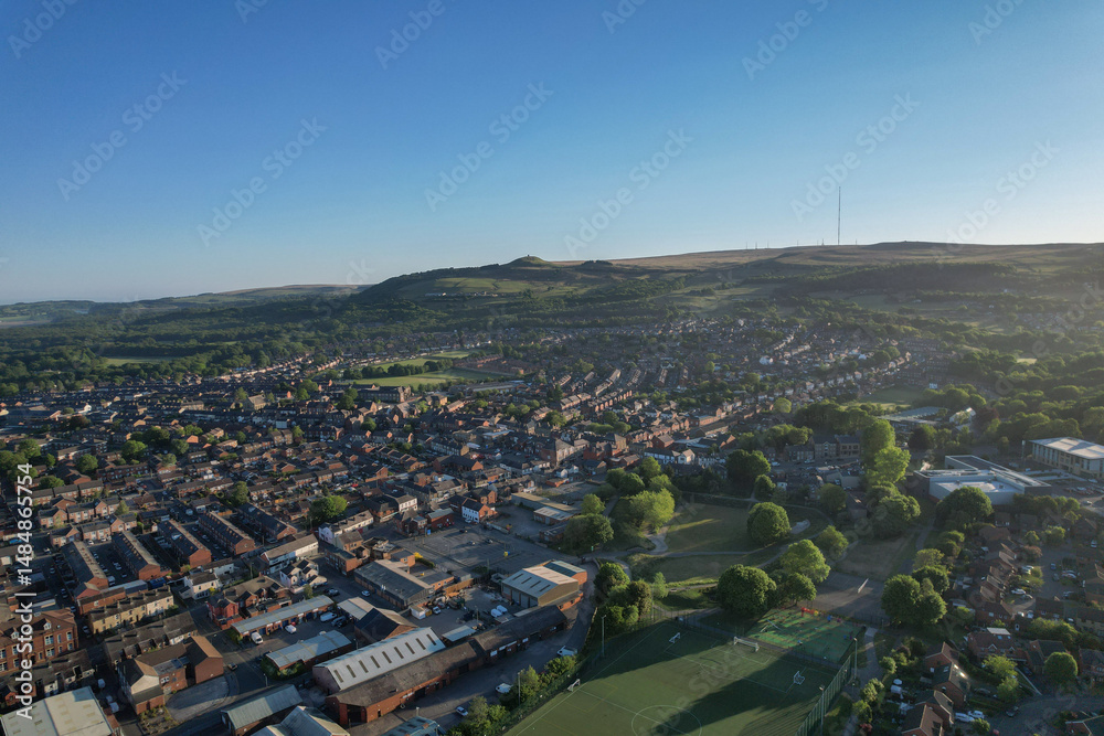 Obraz premium Aerial view of Horwich village in Bolton UK with Rivington Pike in the background.