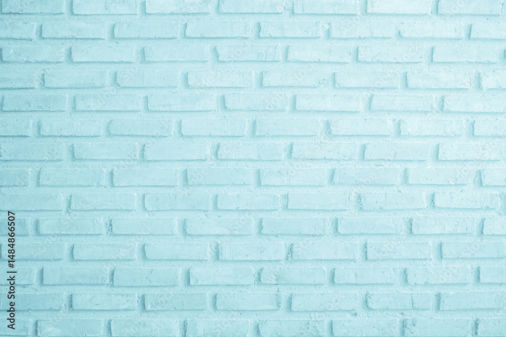 Obraz premium Brick wall painted with pale blue paint pastel calm tone texture background. Brickwork and stonework flooring interior rock old pattern clean concrete grid uneven bricks design stack backdrop.