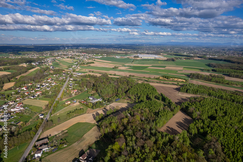 Fototapeta Naklejka Na Ścianę i Meble -  Aerial View of a Rural Landscape with Houses, Fields, and a Connecting Road in Poland
