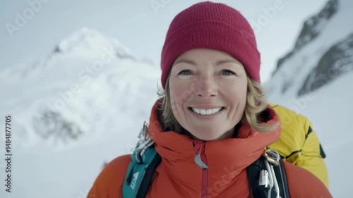 Smiling mountaineer in snowy landscape showcasing adventure and exploration in high-altitude environment