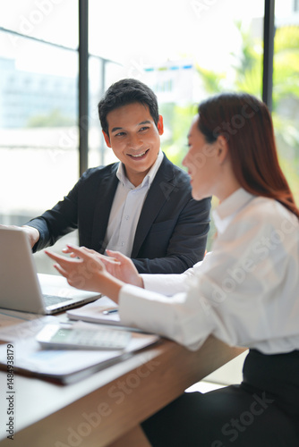 Asian office employee supervising Mentor training trainee at office