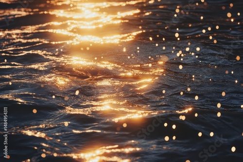 Fototapeta Naklejka Na Ścianę i Meble -  Golden sunrise over calm ocean waves sparkling in light