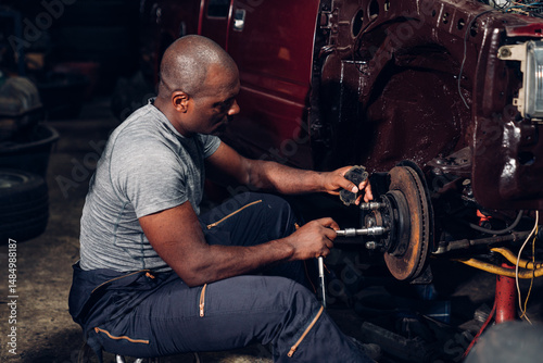 Auto mechanic are checking and repair maintenance auto engine is problems at car repair shop.