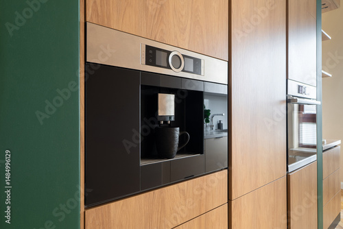 Konstfotografi Built-in coffee machine integrated in wooden kitchen cabinets