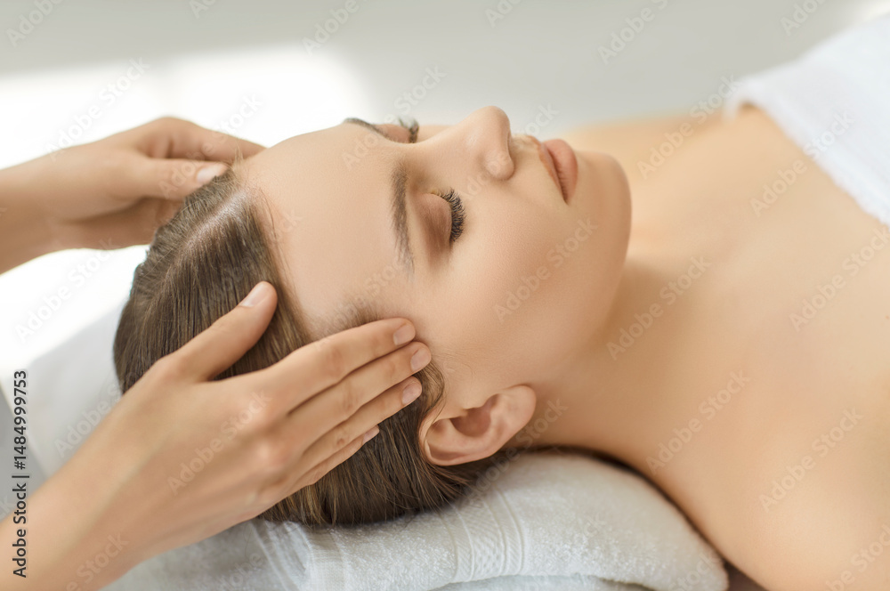 Cosmetologist gently massages female temple muscles performing face, head spa massage, skin, relaxed girl getting rejuvenating in salon, clinic, therapist helping with headache pain, relaxation Cosmetologist gently massages female temple muscles performing face, head spa massage, skin, relaxed girl getting rejuvenating in salon, clinic, therapist helping with headache pain, relaxation