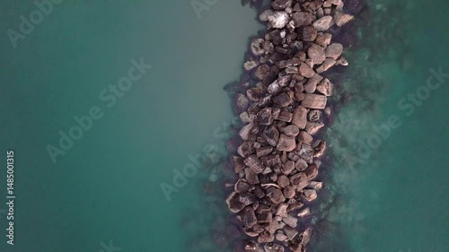 Aerial drone video of the Adriatic Sea at sunrise off Porto Potenza, Italy. Peaceful flyby capturing calm waters, golden reflections, and serene coastal beauty.